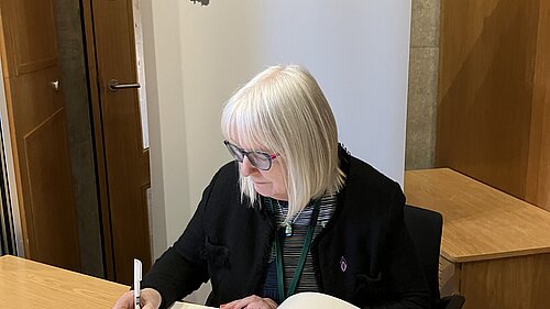 Beatrice Wishart signing The Book of Commitment organised by the Holocaust Education Trust.